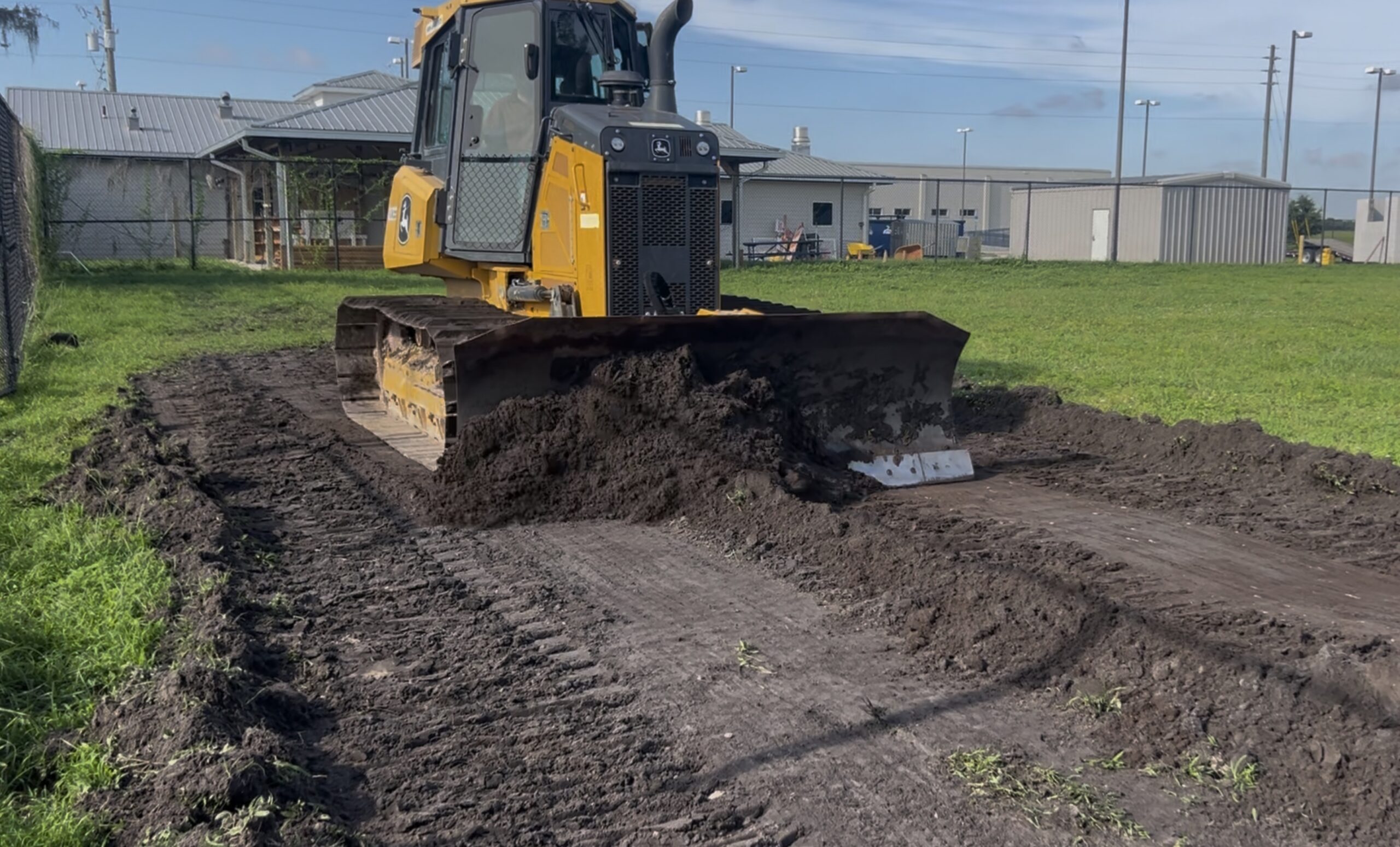 John Deere bulldozer performing precision grading for Orange County Florida police training facility site preparation by Brannigan Land Services