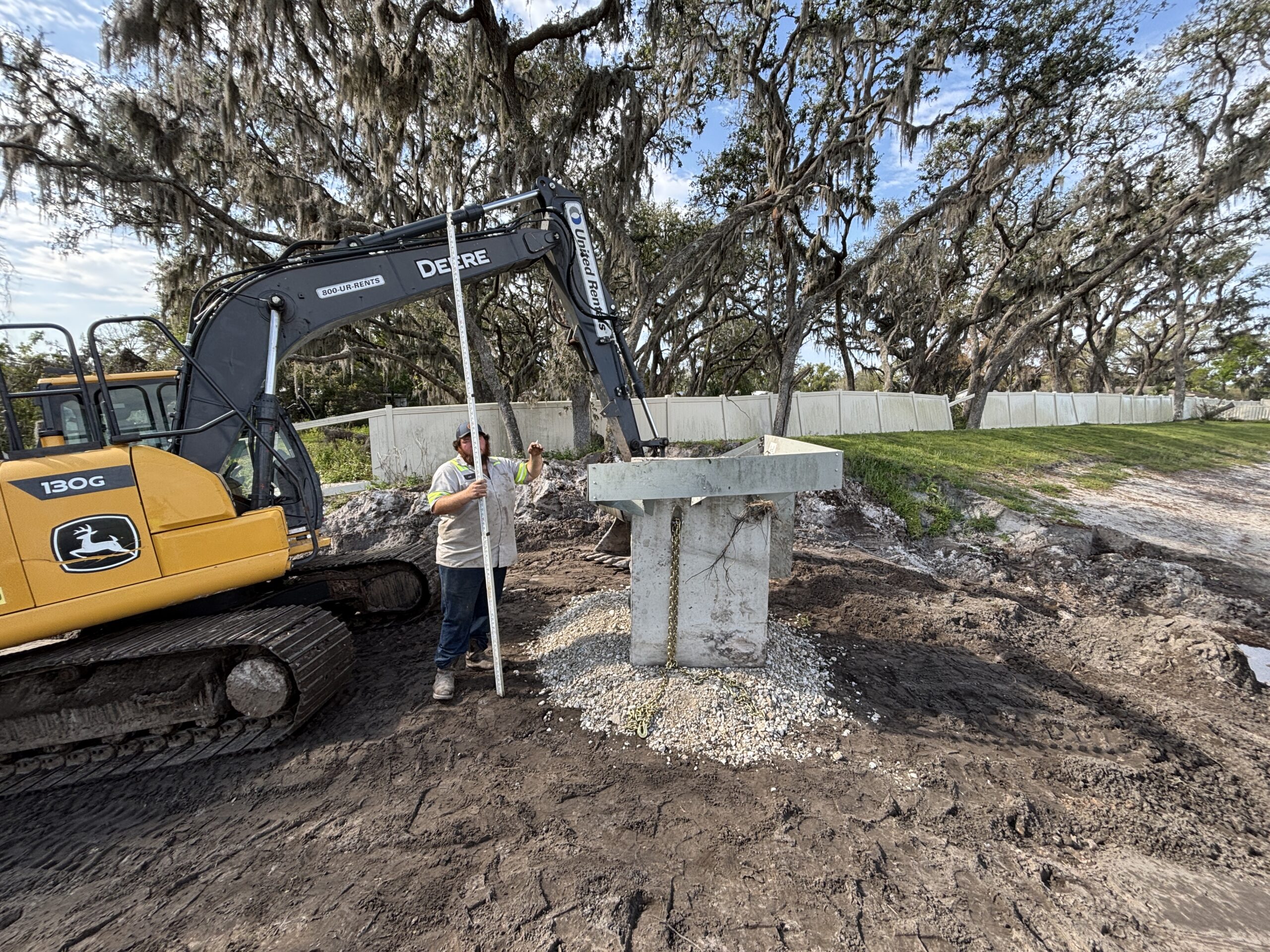 Excavation and site prep for restoring retention pond in Central Florida creating level foundation area for construction