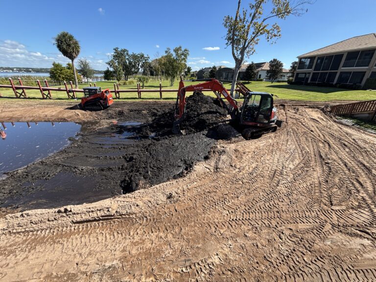 Brannigan Land Services excavator and skid steer working on a retention pond excavation and grading project in Central Florida
